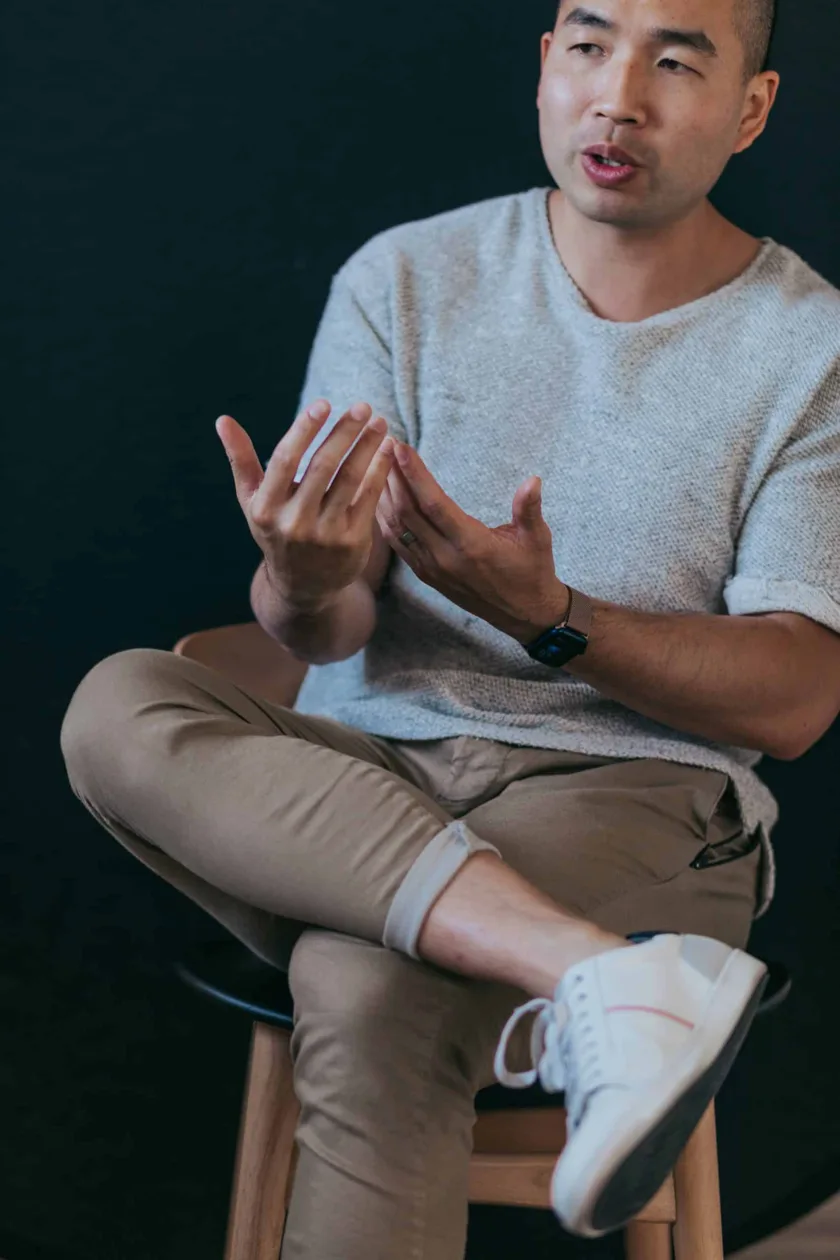 Phil Chan, seated, talking with his hands